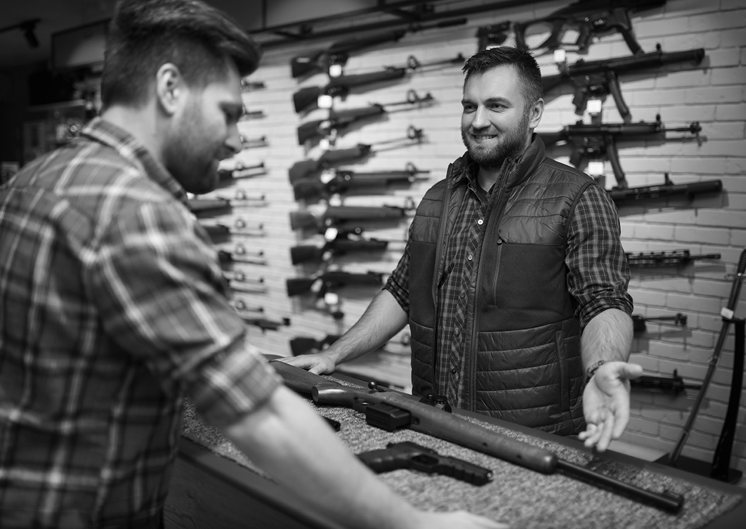 A salesman helping a customer buy a firearm