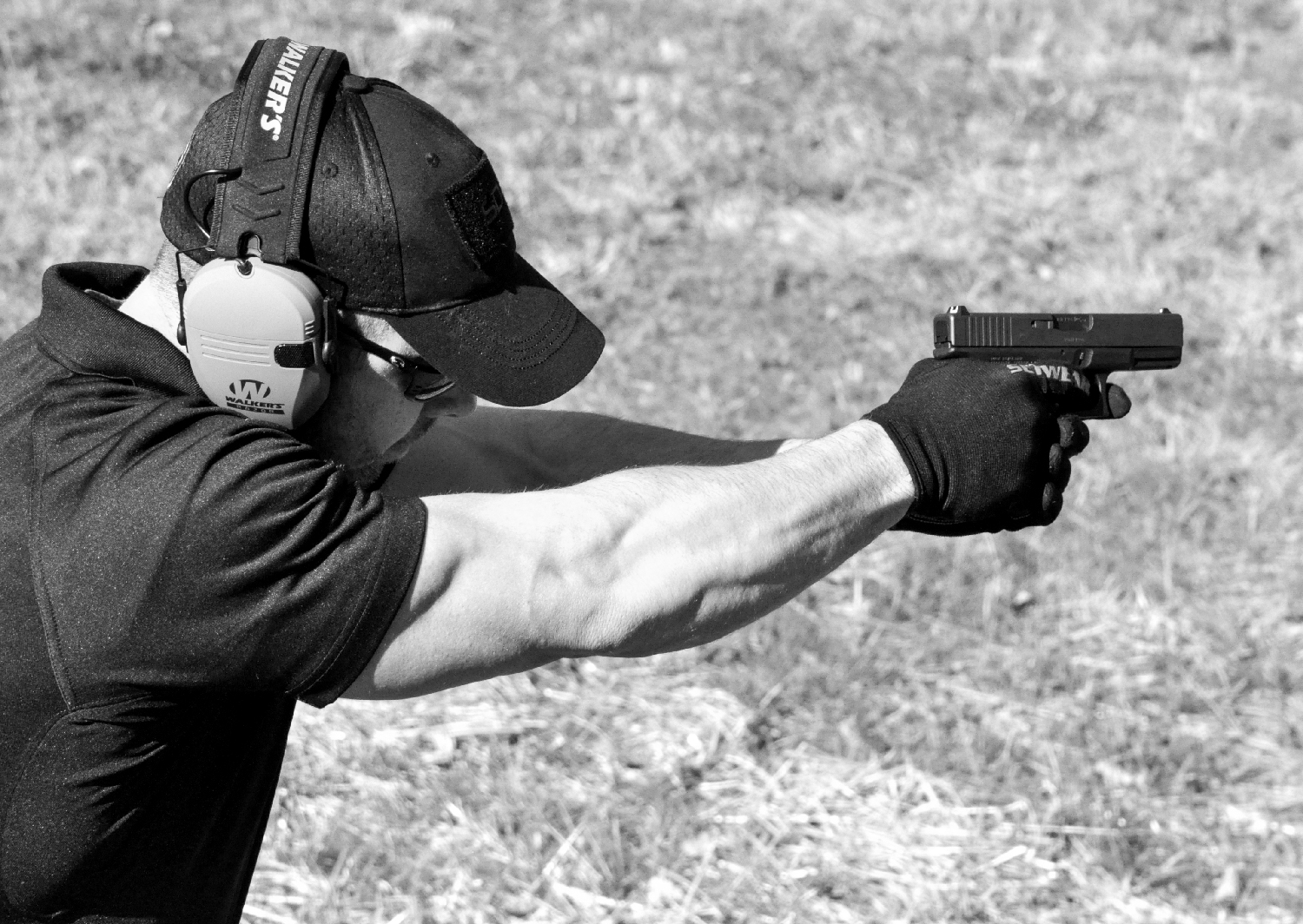 A man aiming a Glock pistol
