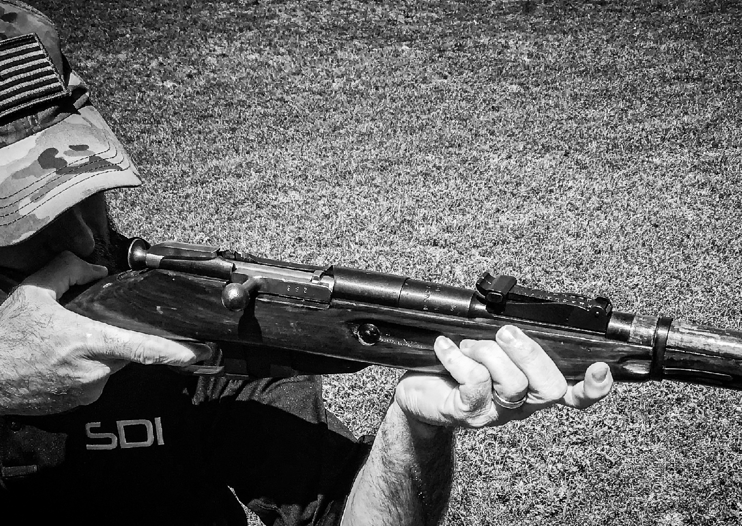 A man aiming a Mosin-Nagant rifle