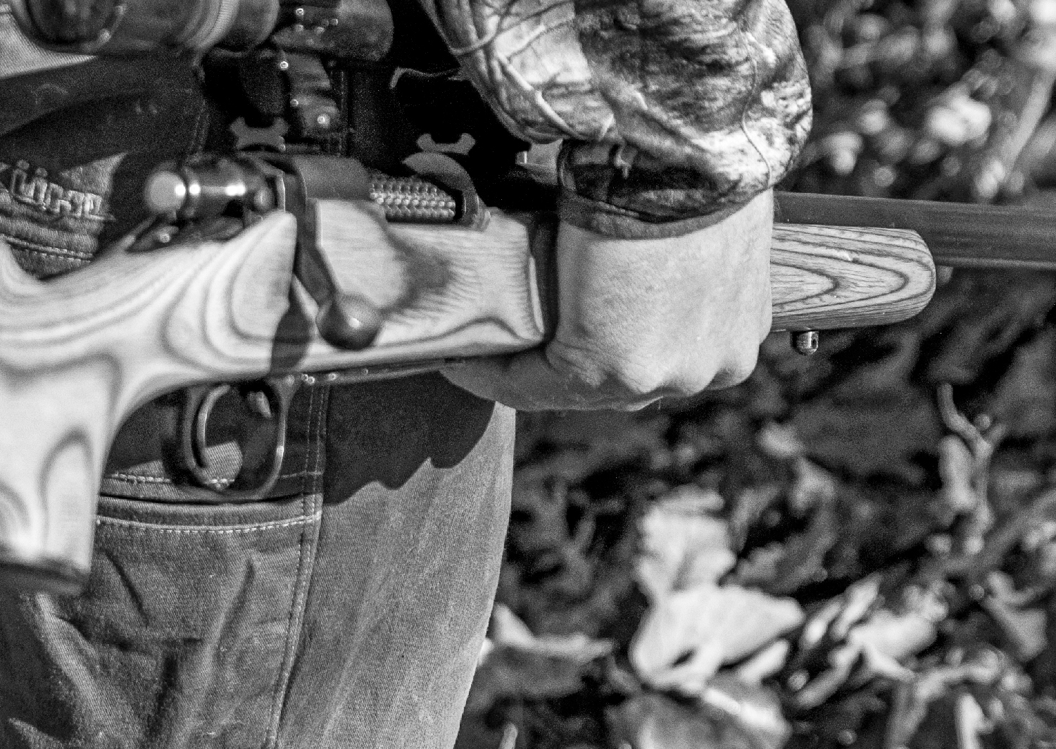 A closeup shot of a man holding a rifle